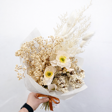 Load image into Gallery viewer, Neutral everlasting dried flower bouquet with baby's breath, bunny tails and poppies held in hand