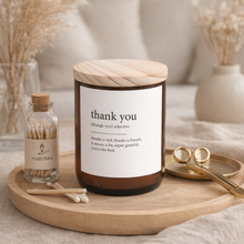 Load image into Gallery viewer, Thank You candle in amber glass jar with wooden lid styled on a wooden tray with matches and wick trimmer in a neutral home setting