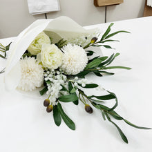 Load image into Gallery viewer, Bouquet of white flowers with green leaves on a white surface

